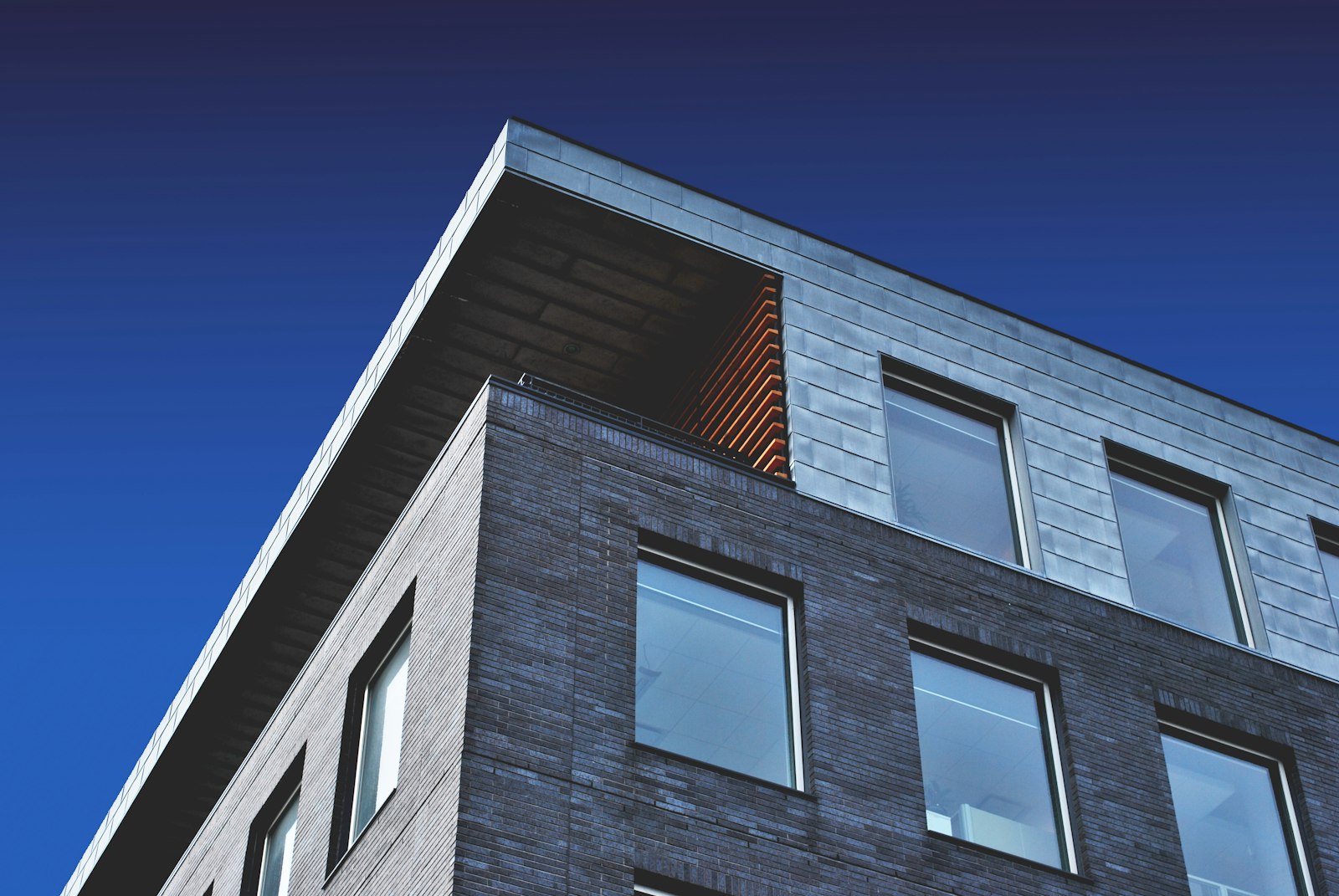 Illustrative photograph of a commercial brick and metal facade. Not a completed company project.