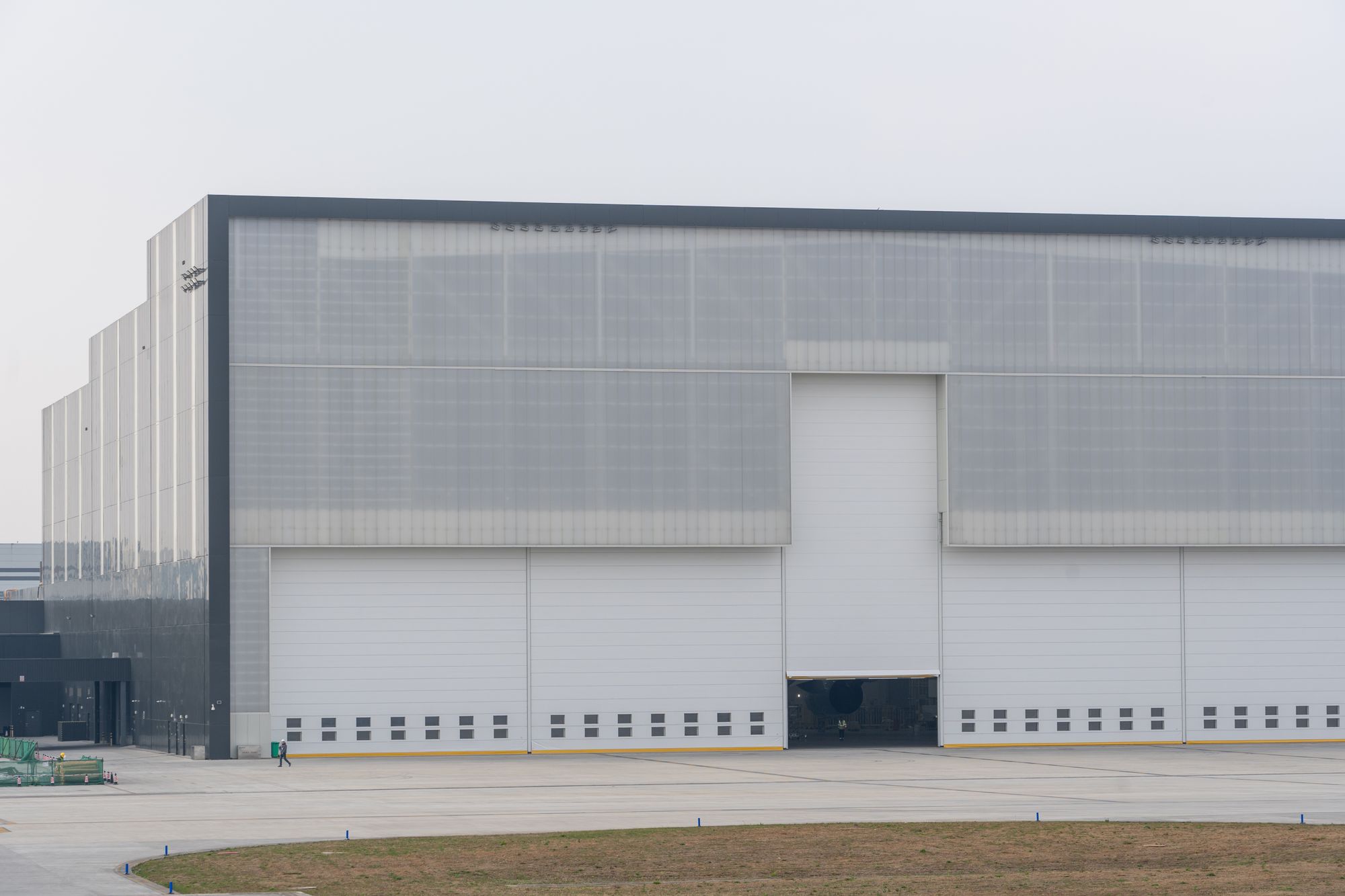 Illustrative photograph of a modern industrial warehouse exterior. Not a completed company project.