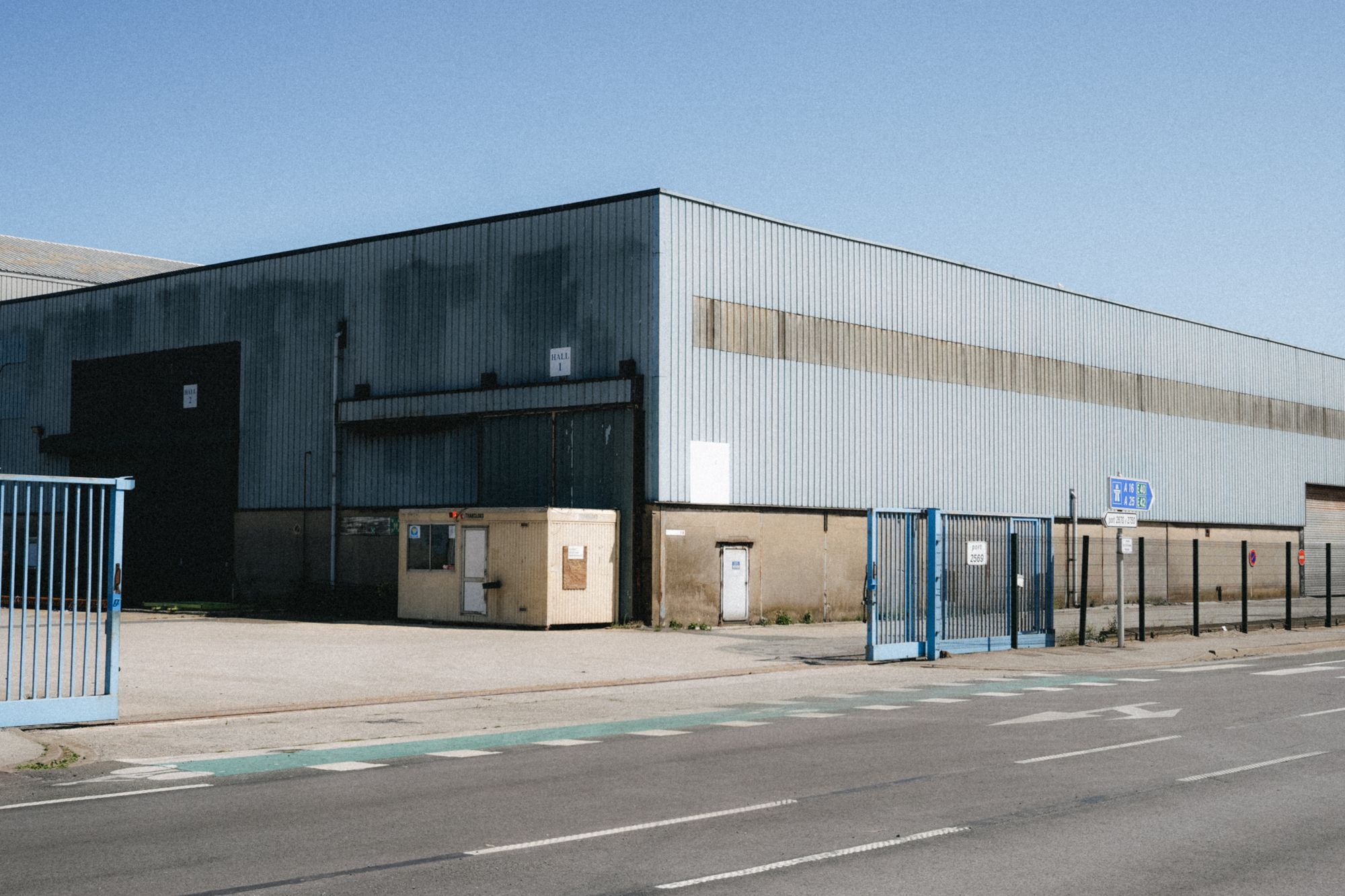 Illustrative photograph of a metal industrial warehouse. Not a completed company project.